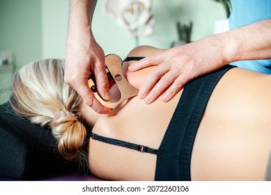 IASTM mysofacial Release For Rhomboid And Back Pain Using Smart Tools, Therapist using IASTM instrument to treat scapular pain - Shutterstock ID 2072260106