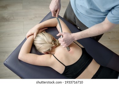 IASTM Treatment, Girl Receiving Soft Tissue Treatment On Her Neck With Stainless Steel Tool