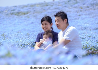 IBARAKI, JAPAN - APRIL 20, 2018: Baby Boy And Family In The Blue Flower (Nemophila Or Baby Blue Eye) Garden At Hitachi Seaside Park.