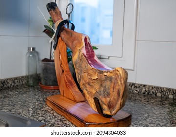 Iberian ham leg in a ham holder in the kitchen