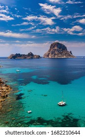 Ibiza, Spain - June 16, 2014: Es Vedra. One of the best known places on the island of Ibiza. Located on the Cala d'Hort beach. In summer it is common to see boats at anchor enjoying the crystal clear