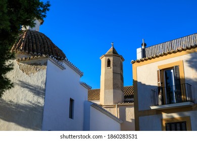 Ibiza Town, Ibiza / Spain - 11 04 18: Authentic Old Town View Of Sunlit Churches And A Pretty House With Balconies In Warm Light