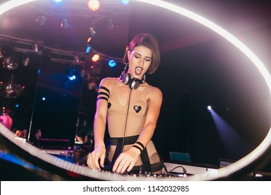 Ibiza/Spain-June 15 2018: Cute Active Fashionable DJ Girl Playing In A Night Club