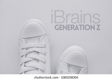 IBrains Or Generation Z Concept. Member Of So Called Selfie Generation In White Casual Canvas Shoes Standing Over The Title, Top View