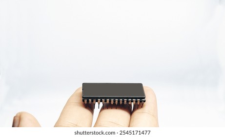 IC or integrated circuit is an integrated electronic component that functions to process, control and manipulate electronic devices, closeup with hand 28 pin