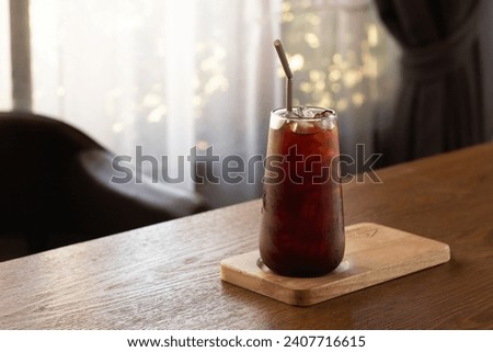 Ice americano coffee in a tall glass with , ice cubes and beans on a dark concrete table. Cold summer drink with tubes on a table
Black Russian Cocktail with Vodka and Coffee Liquor. 