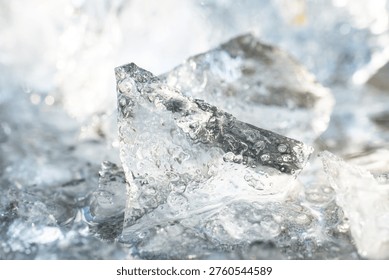 Ice background. Chunks of crushed ice structure. Chunks of ice texture in sunlight. Frost and cold weather. 