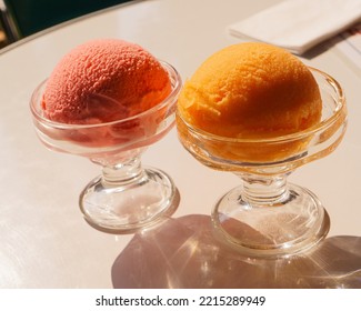 Ice Ball  In Cocktail Glass Tangerine And Cherry