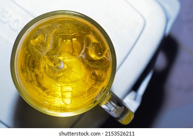 Ice And Beer In A Clear Glass On A Light Background In Top View Placed On A Cooler Box.