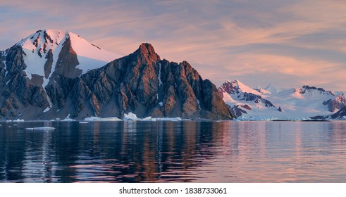 Ice Bergs At Sunset In Antartica