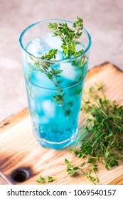 Ice Blue Cocktail With Thyme. Blue Curacao Liqueur. Summer Drink