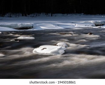 Ice Breaking Up In Spring At A  Scandinavian River. Long Exposure For Smoothly Flowing Water. Shot In Sweden, Europe