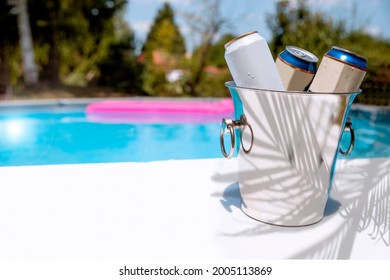 Ice Bucket With The Beer At The Pool. Prepare For The Pool Party In The Backyard. Beer Cans Cooling By The Pool. Copy Space