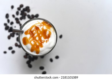 Ice Caramel Latte With Coffee Beans Isolated On White Background Top View Closeup