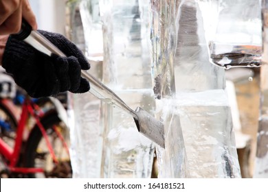 Ice Carver Using Chisel To Carve 