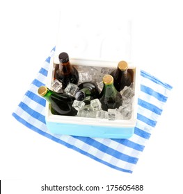 Ice Chest Full Of Drinks In Bottles On Color Napkin, Isolated On White