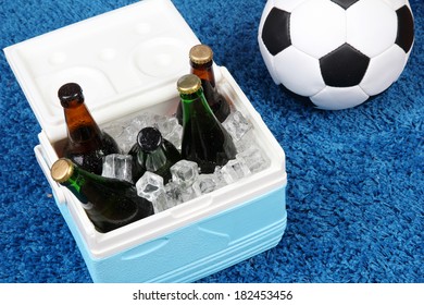 Ice Chest Full Of Drinks In Bottles On Color Carpet Background