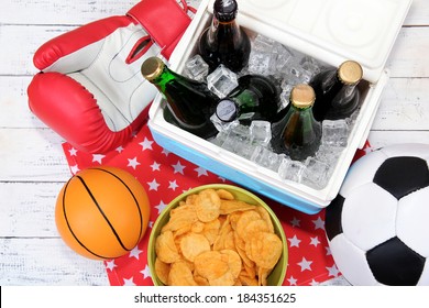 Ice Chest Full Of Drinks In Bottles On Color Napkin, On Wooden Background