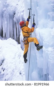 Ice Climber Struggles Up A Frozen Waterfall.
