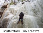 Ice climbing a beautiful frozen waterfall in the Flume Gorge, New Hampshire, USA