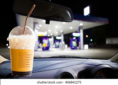 Ice Coffee, Blur Image Of Gas Station As Background.