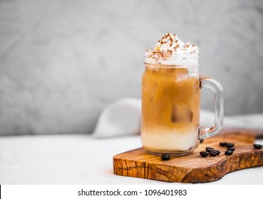 Ice coffee cup with cream. Ice summer refreshing coffee drink with cream