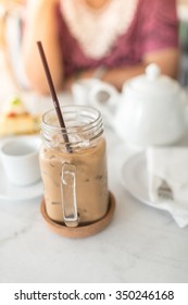 Ice Coffee On Table With White Jar.