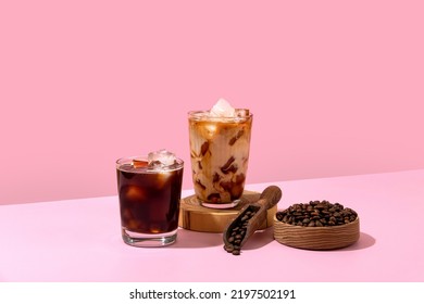 Ice coffee in a tall glass with cream poured over and coffee beans. Set with different types of coffee drinks on a pink table. - Shutterstock ID 2197502191