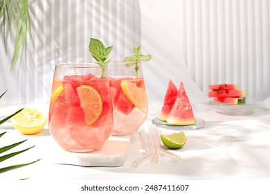 Ice cold homemade lemonade or cocktail with mint, watermelon and fruit, a recipe for a refreshing summer drink. Two glasses with fruit drink on sunny table, detox diet and weight loss concept, - Powered by Shutterstock