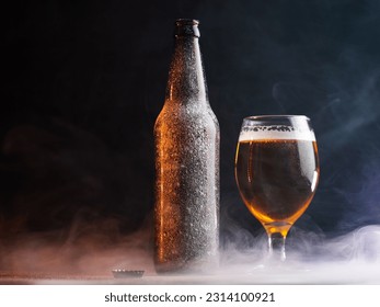 ice cold light beer in a glass. Bottle covered with ice. Dark background, copy space - Powered by Shutterstock