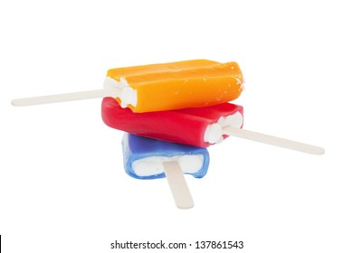 An ice cold stack of fruit flavored creamsicles.  Shot on white background.