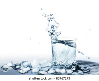 Ice Cold Water Drink In A Glass Standing In Water With Ice Cubes And Water Splashing