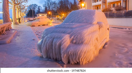 Ice Covered Car By Lake Geneva At The Town Of Versoix, Geneva, Switzerland In A Winter Morning.