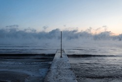 Ice Covered Concrete Pier Leading Out To Fog Covered Lake Michigan On Bitterly Cold And Freezing Day In Chicago
