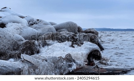 Ice Covered Rocks on the Shoreline of the lake in winter
