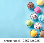 Ice Cream Assortment. Various ice creams or gelato on blue background, copy space. Frozen yogurt  in small paper cups - healthy summer dessert.