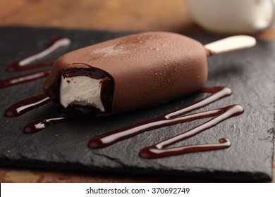 Ice Cream Bar Coated With Chocolate On A Slate Board