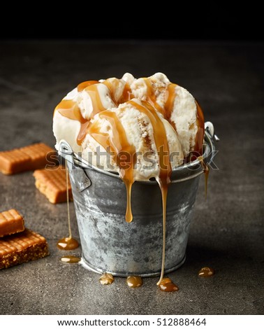 ice cream with caramel sauce on dark gray table