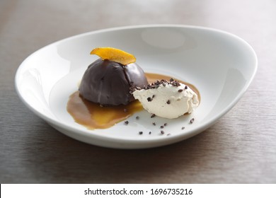 Ice Cream And Chocolate Dome With Candied Orange Peel And Carmel Drizzle