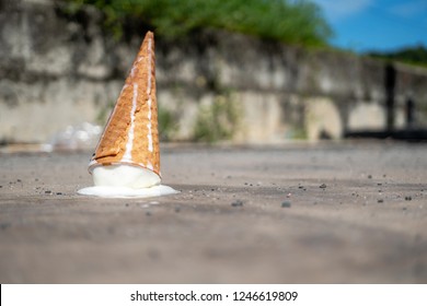 ice cream cone falling on the road
