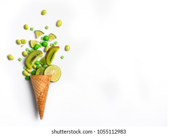 Ice Cream Cone Flat Lay Image With Green Candy And Kiwifruit Packing Into The Cone.