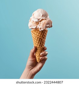 Ice cream cone on a blue background. The woman holding the ice cream by hand.
 - Powered by Shutterstock