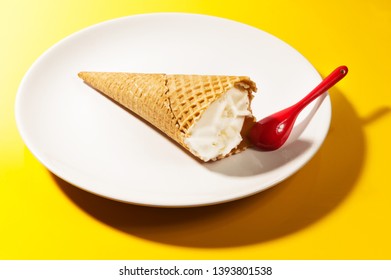 ice cream cone in plate on yellow background - Shutterstock ID 1393801538