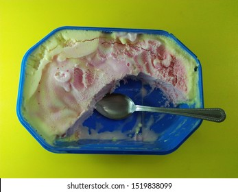 Ice Cream In Container With Spoon