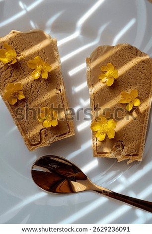 Ice cream dessert decorated with small yellow flowers. A picture like on Pinterest.