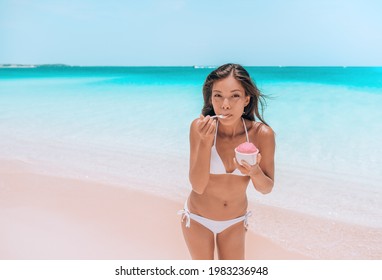 Ice Cream Dessert On Beach. Happy Asian Woman Eating Delicious Frozen Fruit Yogurt Or Acai Smoothie Bowl Healthy Food On Caribbean Beach Vacation Travel.