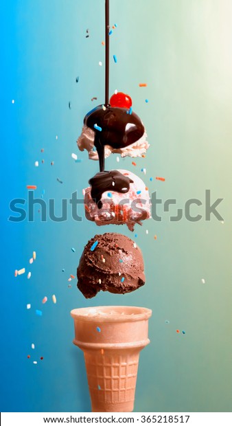 Ice Cream Float.  Three scoops of ice cream\
hovering over an ice cream cone.  Cherry on top, and chocolate\
syrup drizzling down with candy sprinkles falling around.  Blue and\
green gradient background