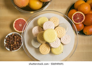 Ice Cream French Macarons on a white plate surrounded by sliced pink grapefruit