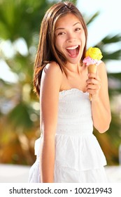 Ice Cream Girl Excited And Happy Eating Ice Cream Cone On Beach During Summer Vacation. Lovely Sweet Mixed Race Asian Chinese / Caucasian Young Woman Outside.