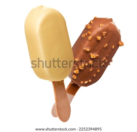 Ice cream in a glaze of white chocolate and in a glaze of milk chocolate and nuts on wooden sticks. Isolate on a white background